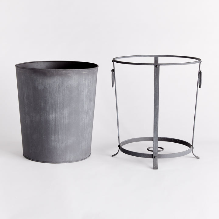 Large iron planter with its removable liner lifted out beside the support frame and ring handles. Industrial Transitional