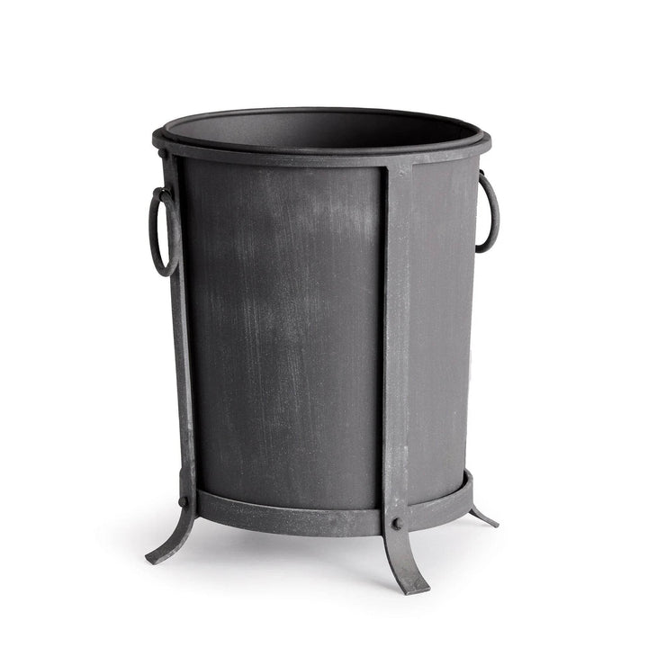 Small iron planter with a tapered round body, aged zinc finish, ring handles and a raised frame. Industrial Transitional