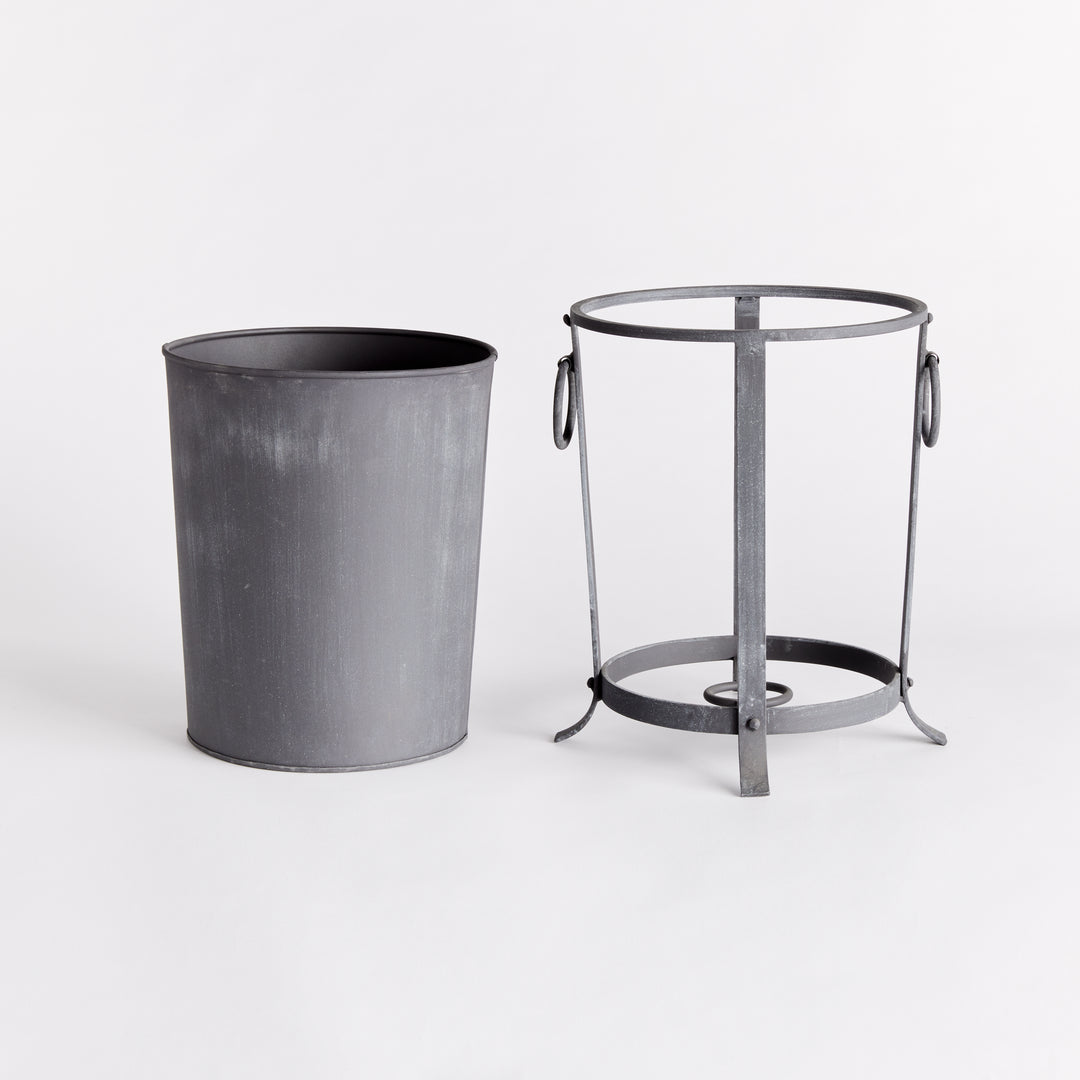 Small iron planter with its removable liner lifted out beside the support frame and ring handles. Industrial Transitional