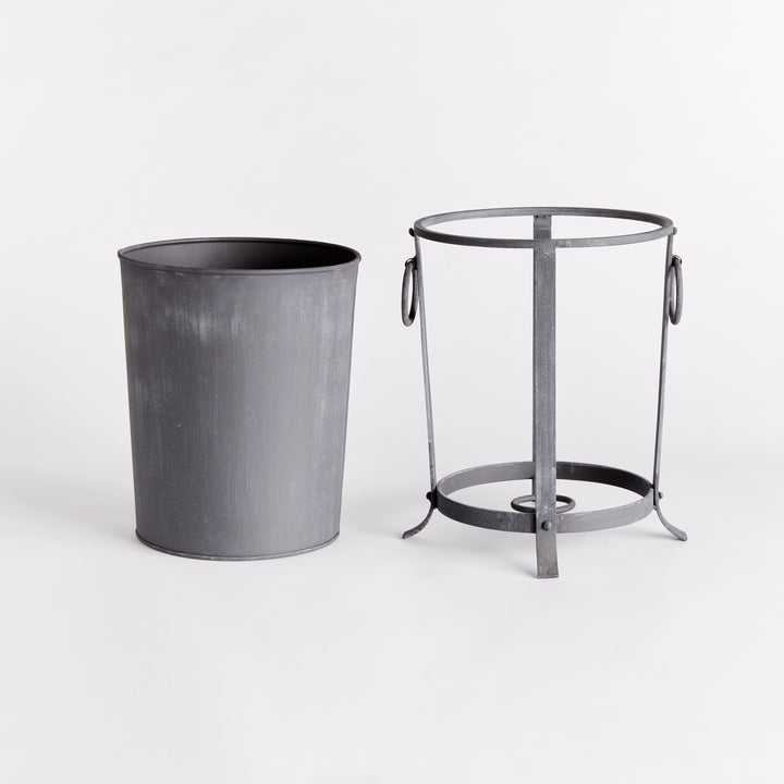 Small iron planter with its removable liner lifted out beside the support frame and ring handles. Industrial Transitional