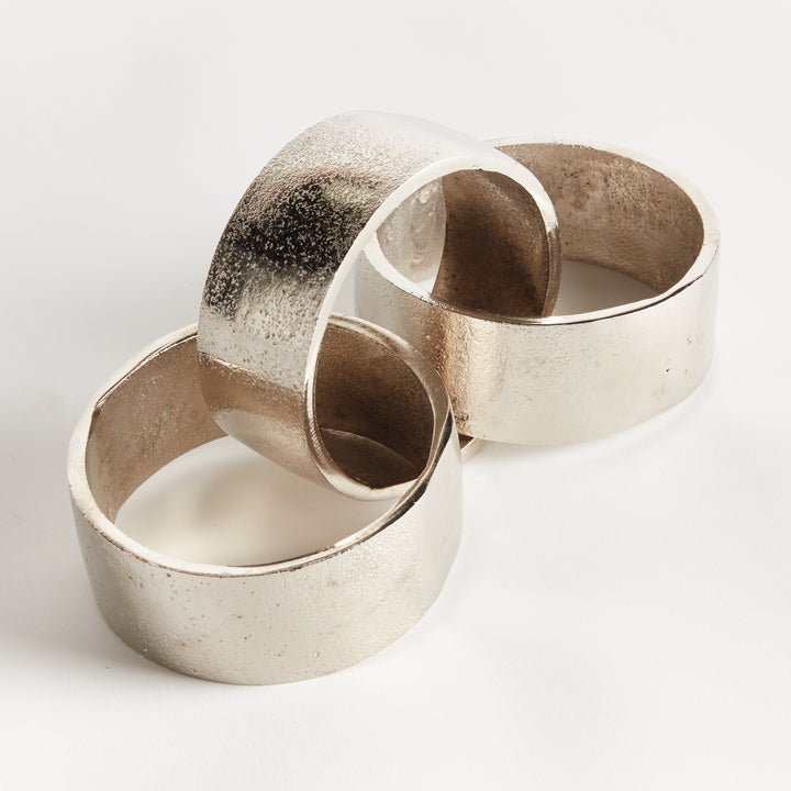 Angled view of silver chain-link sculpture with cast aluminum links open circles and textured metal on white - Modern Organic