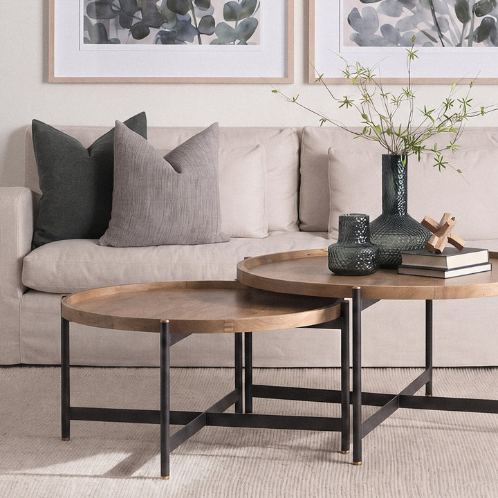 Round mango wood coffee table styled in a living room with neutral seating and layered décor – Modern Organic