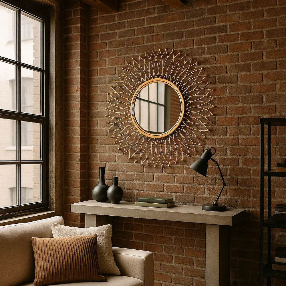 Round modern gold mirror styled in a minimalist loft interior with high ceilings and industrial finishes.