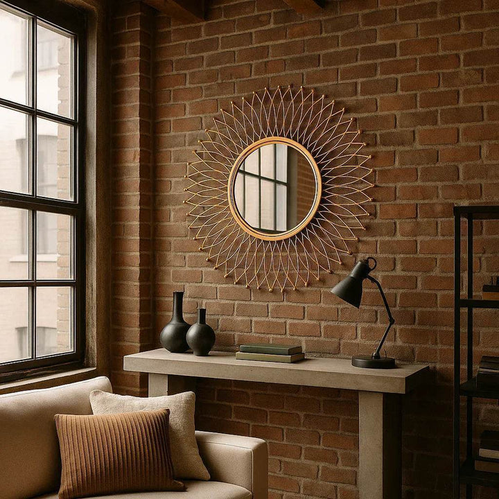 Round modern gold mirror styled in a minimalist loft interior with high ceilings and industrial finishes.