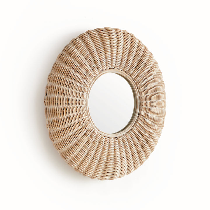 Close-up of handwoven whitewashed rattan frame on round wall mirror, showing natural texture and intricate sunburst weave.
