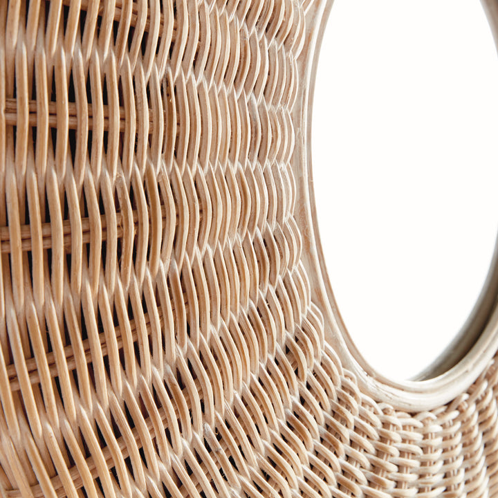Lower edge detail of round rattan mirror in whitewashed finish, highlighting organic scalloped weave and soft tonal variation.
