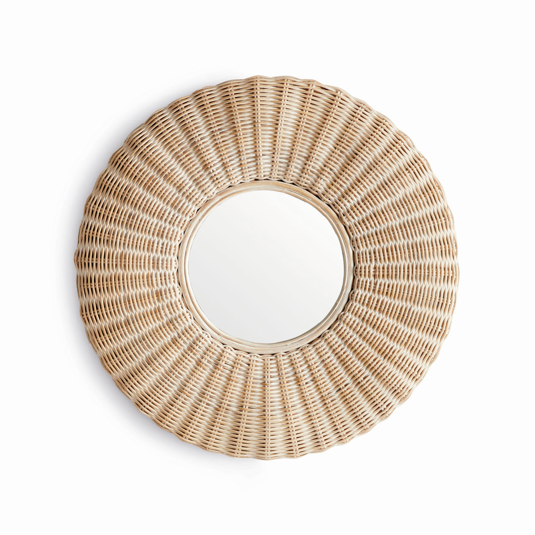 Angled side view of whitewashed round rattan wall mirror showing depth, layered frame, and radial woven texture in soft lighting.