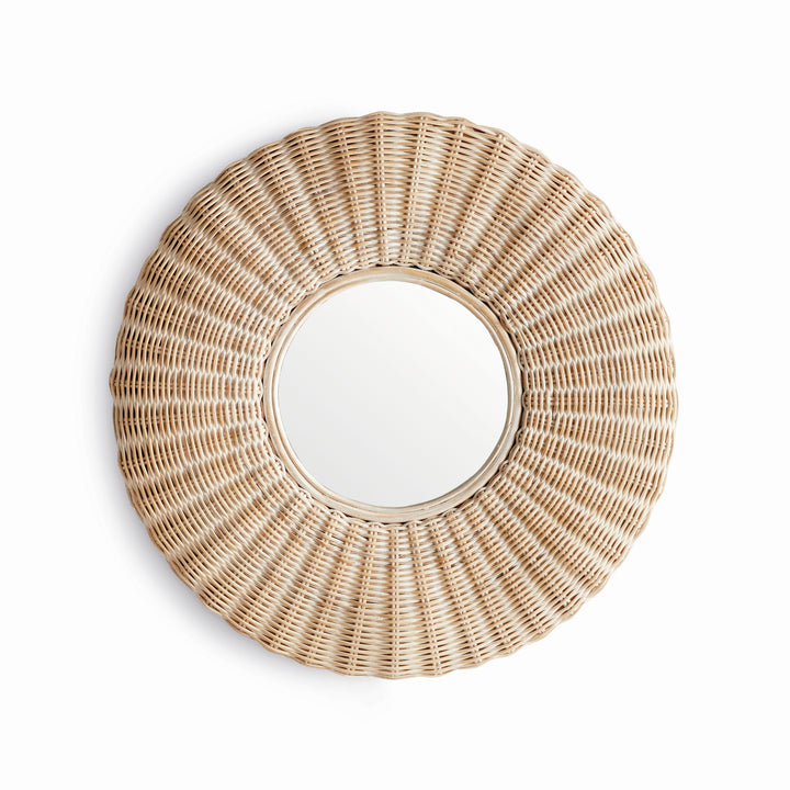 Angled side view of whitewashed round rattan wall mirror showing depth, layered frame, and radial woven texture in soft lighting.
