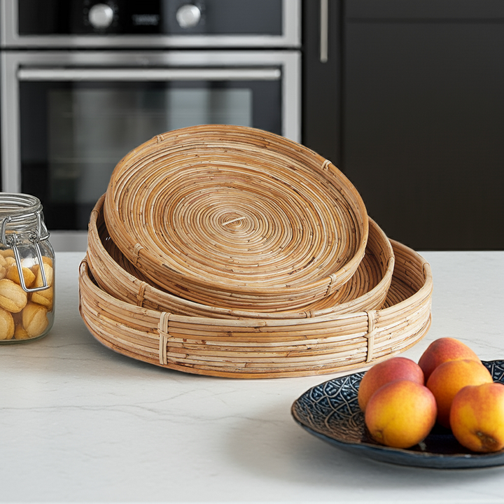 Boho natural round rattan trays styled on kitchen counter with fruit bowl and modern decor