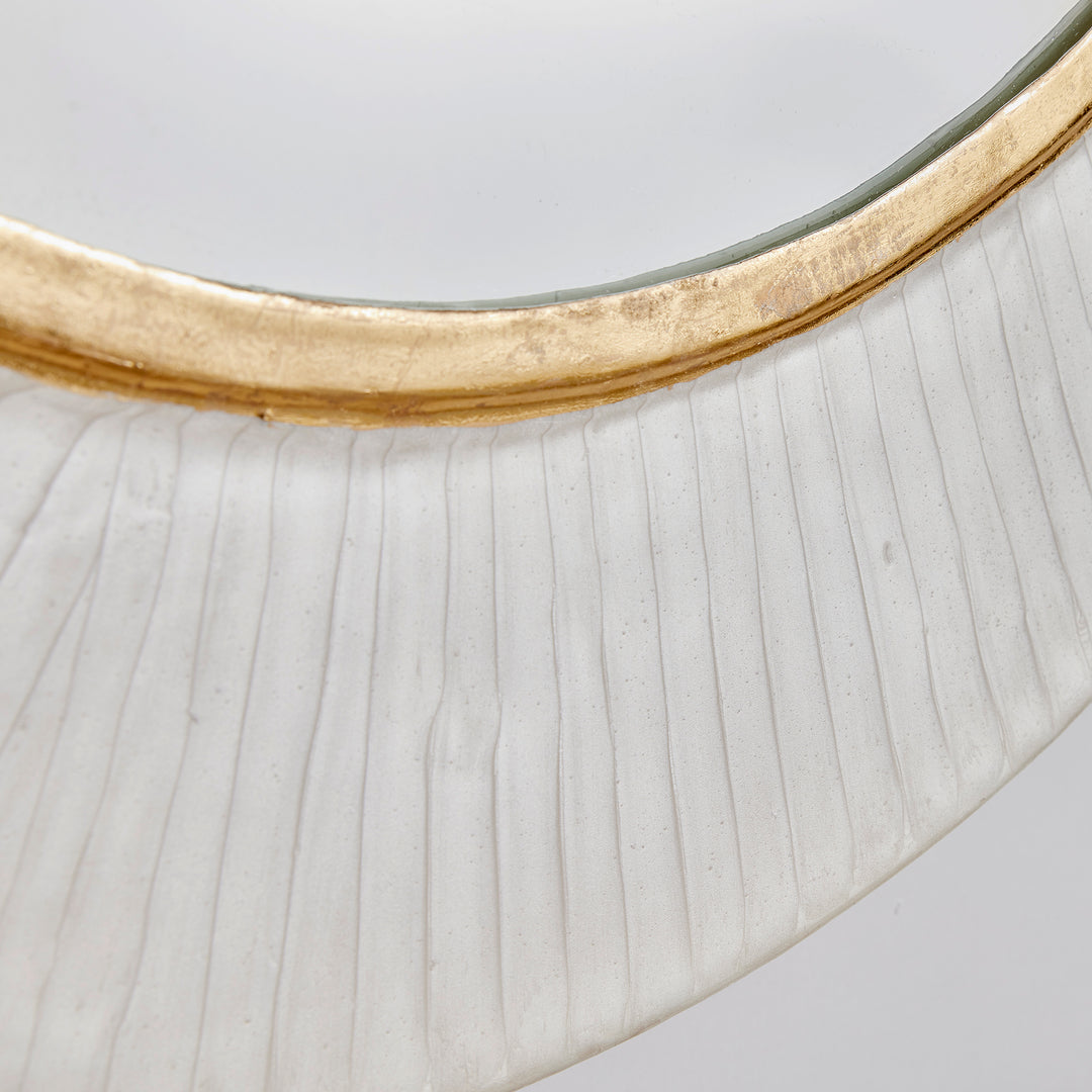 Close-up detail of white enamel round wall mirror with textured finish and hand-applied gold accent trim.