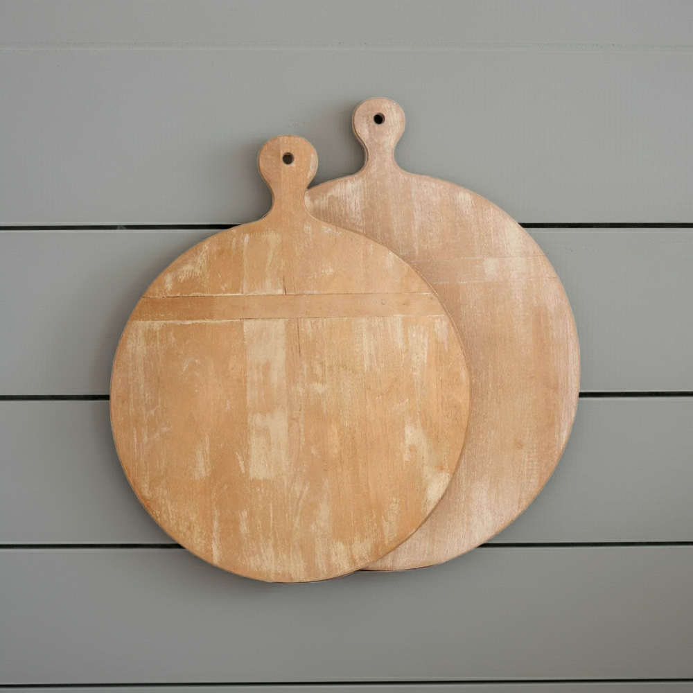 Pair of antique style round wooden cutting boards with handles, whitewashed finish displayed against light gray wall – Farmhouse Vintage
