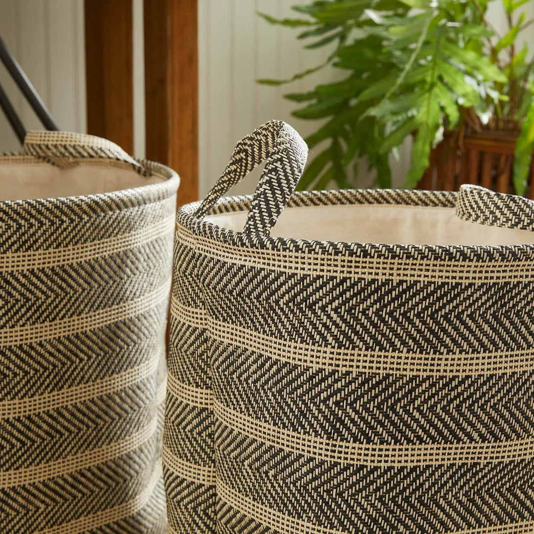 Close-up of round woven storage basket with handles showing weave detail and cotton liner, decorative home accent – Modern Organic.


