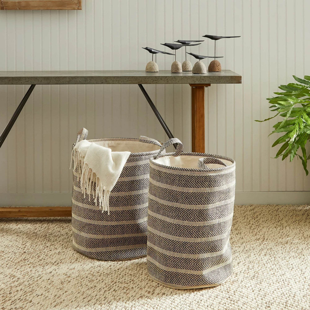 Round woven storage baskets with handles styled with a throw blanket in a cozy room, decorative organization accent – Modern Organic.

