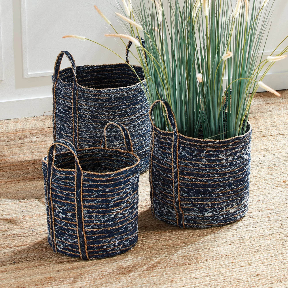 Blue woven denim baskets with seagrass trim styled with indoor plants in a bright room