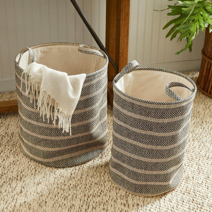 Round woven storage baskets with handles styled near console and rug, black and beige decorative home storage – Modern Organic.

