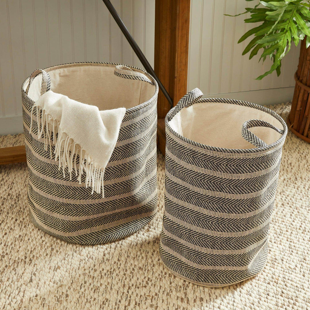 Round woven storage baskets with handles styled near console and rug, black and beige decorative home storage – Modern Organic.

