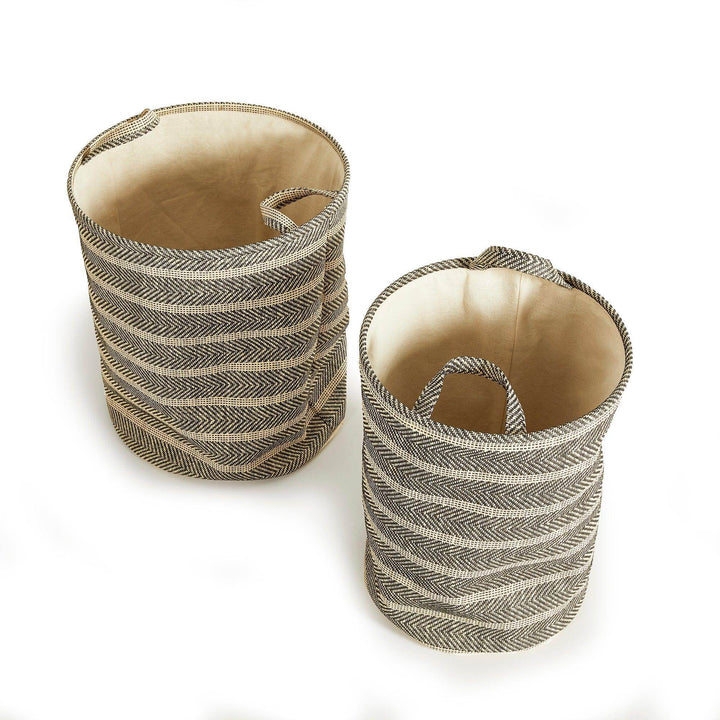 Set of two round woven storage baskets with handles in black and beige, displayed empty, modern indoor organization decor – Modern Organic.

