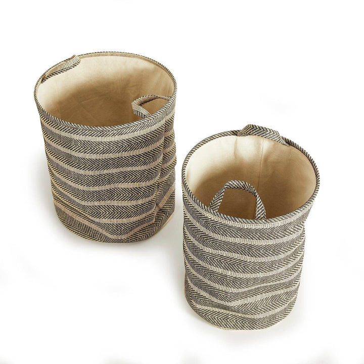 Set of two round woven storage baskets with handles in black and beige, displayed empty, modern indoor organization decor – Modern Organic.

