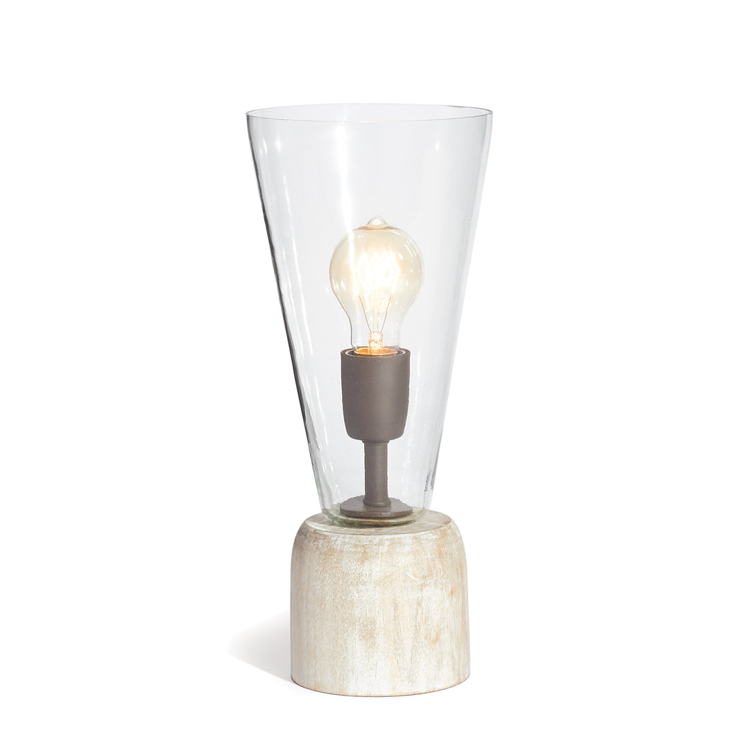 Glass accent lamp with a whitewashed mango wood base, tapered clear glass shade and a visible illuminated bulb - Transitional