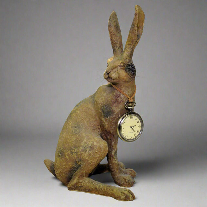 Rustic rabbit decor piece styled with soft shadows – tall resin bunny figure with antique pocket watch necklace

