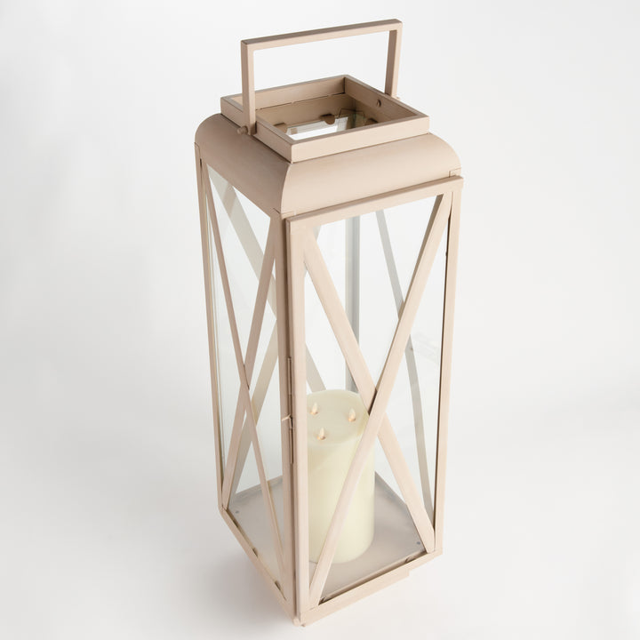 Close-up of sandstone-look outdoor lantern showing decorative cross-brace iron frame and clear glass panel, Modern Organic style