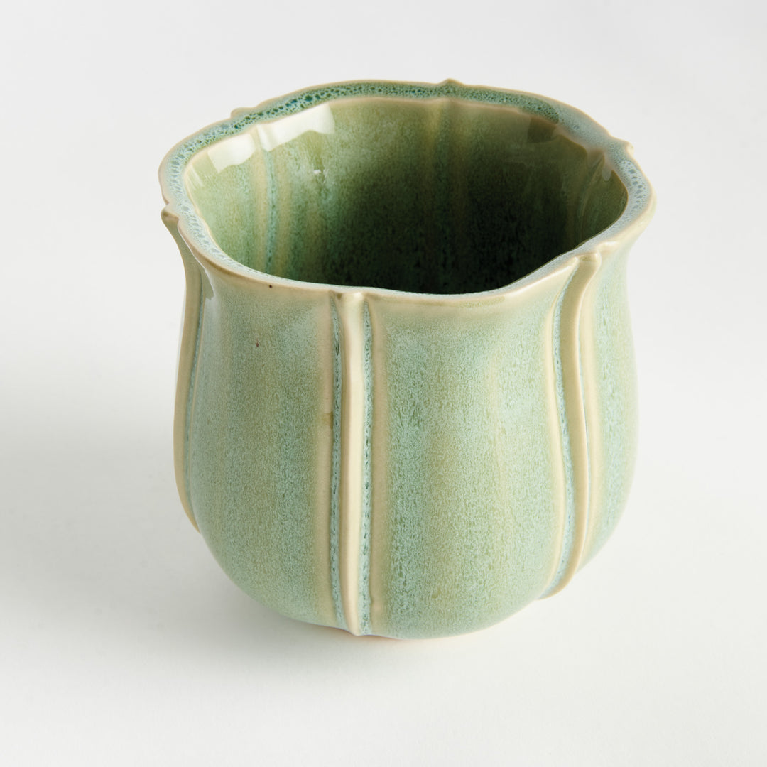 Small green ceramic planter with scalloped rim, artisan glazing, and decorative ribbed stoneware design – European Cottage