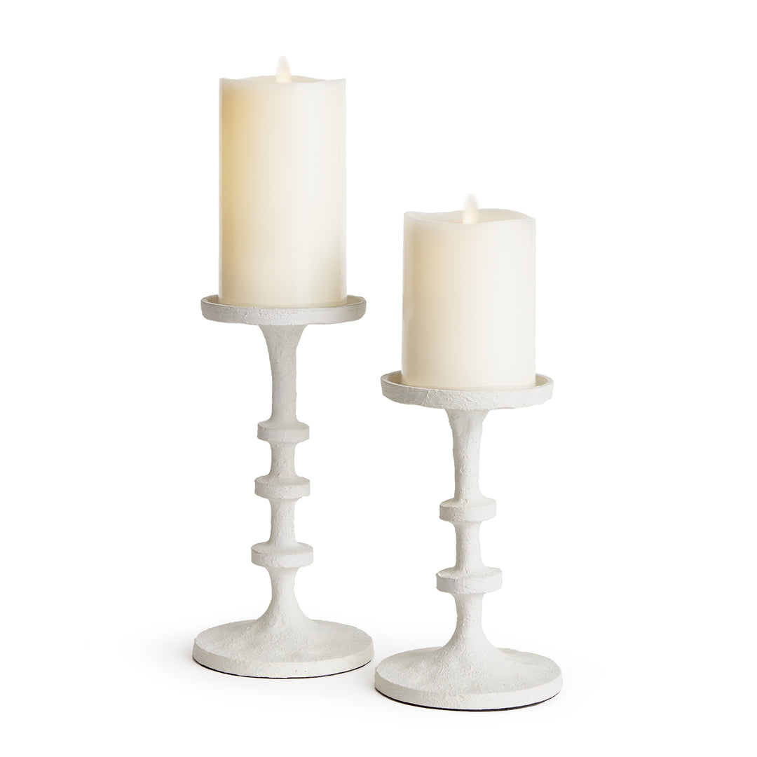White aluminum pillar candle holders with sculptural stacked silhouette for console and tabletop styling – Transitional