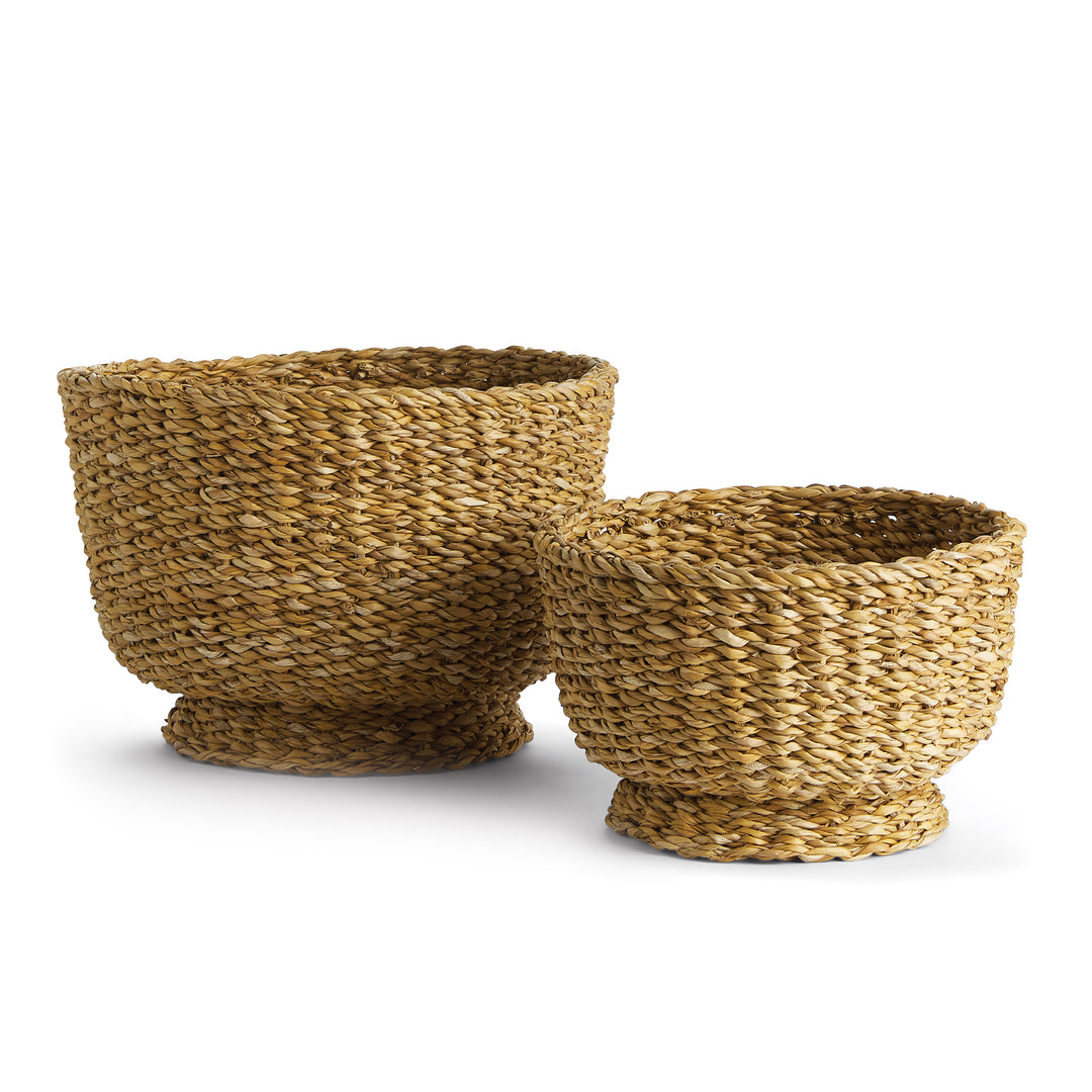Two natural seagrass footed bowls in graduated sizes, with rounded woven sides and round raised bases - Coastal Transitional