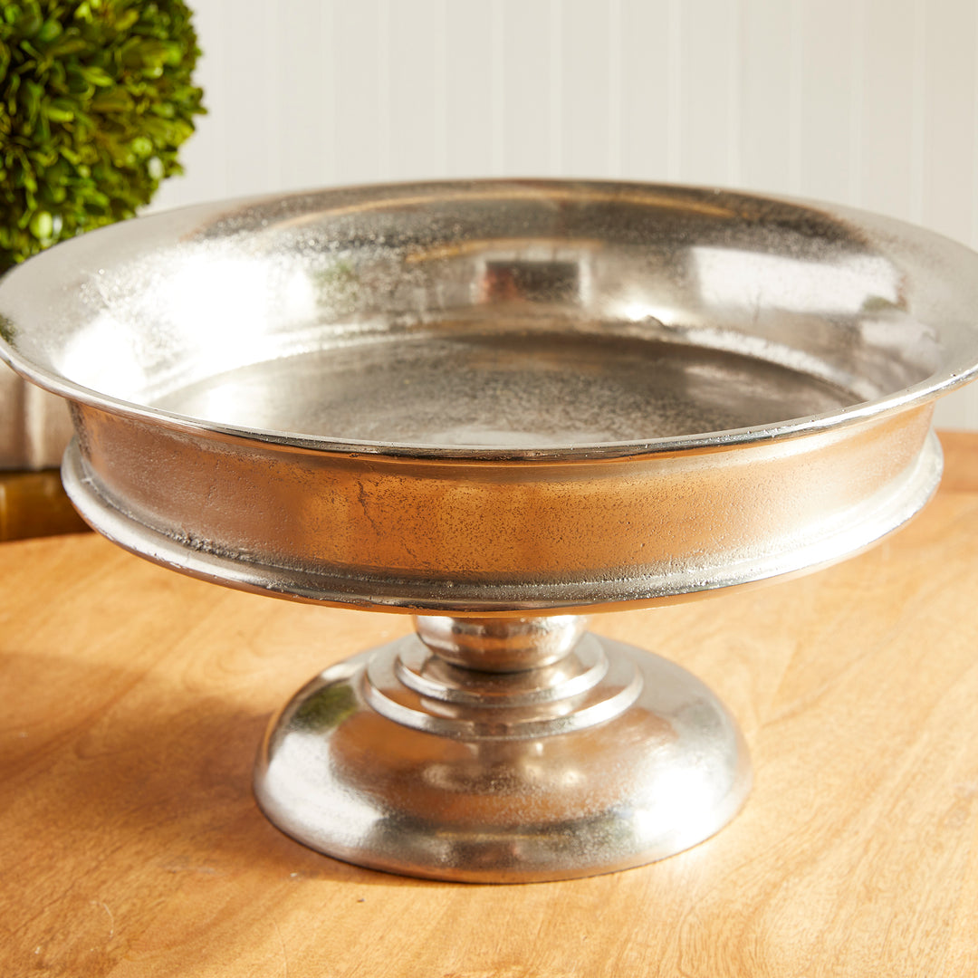 Angled view of round aluminum pedestal bowl with brushed silver finish and wide base – Modern Classic


