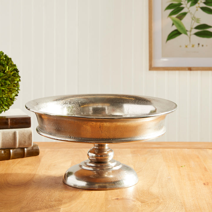 Brushed silver cast aluminum pedestal bowl with round base on wood tabletop, 16 inch wide – Modern Classic

