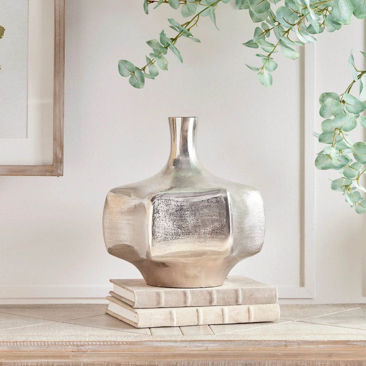 Silver cast aluminum vase styled on books, reflective metallic vase for console or kitchen counter decor

