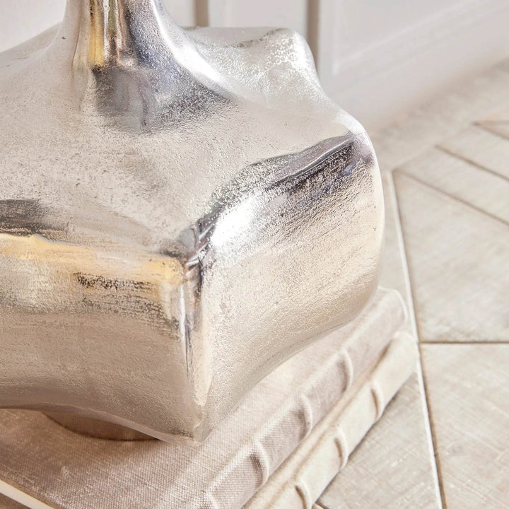 Silver cast aluminum vase styled in a vignette with greenery, modern coastal decor accent for home interiors

