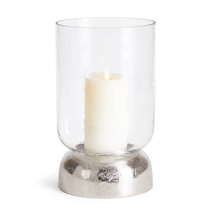 Hurricane candle holder with silver base and glowing pillar candle, styled in natural light – Transitional Modern


