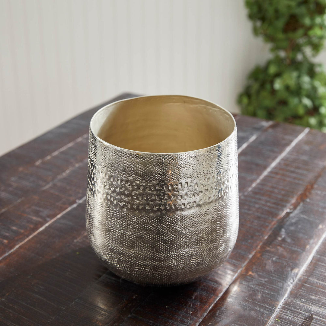Empty silver cachepot with interior visible, styled on dark wood table – Modern Organic.

