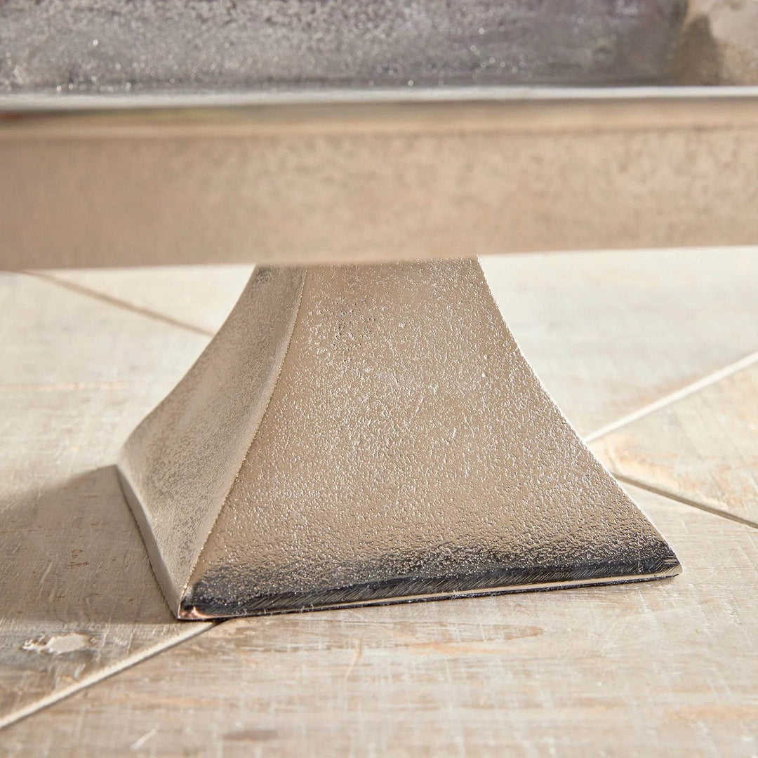 Close-up of brushed nickel pedestal tray base, cast aluminum with subtle texture for modern traditional decorative styling.


