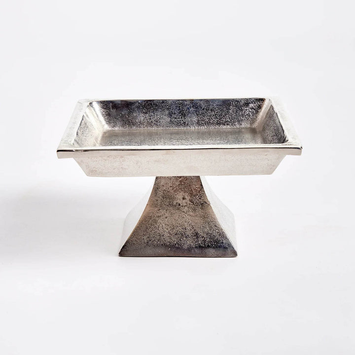 Small silver pedestal tray with square top on aluminum base, brushed nickel finish, displayed for modern traditional decor.

