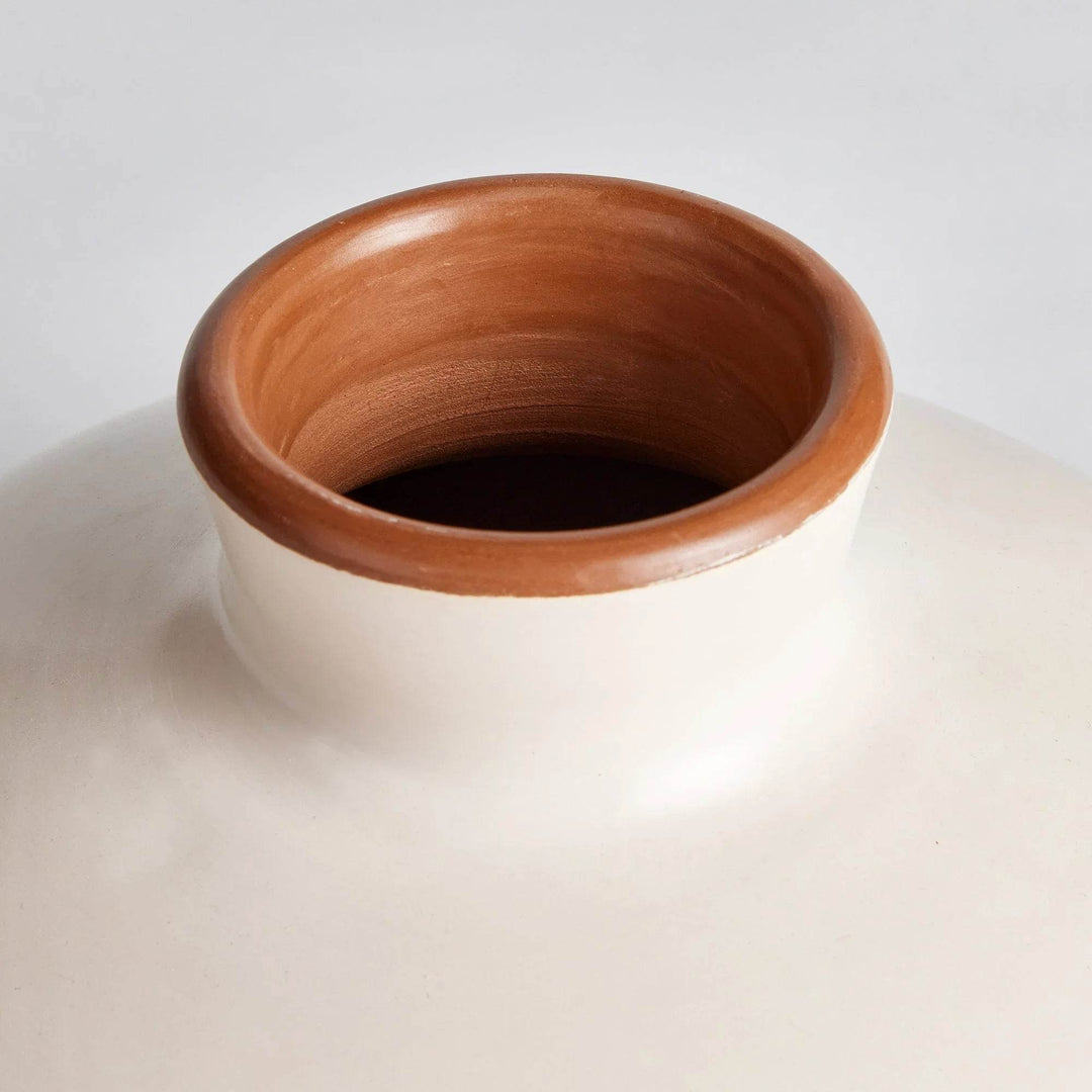 Top view of handcrafted small beige ceramic vase with wide opening and warm clay rim, ideal for styling with faux stems.


