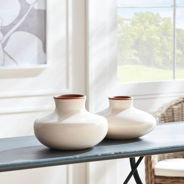 Pair of handcrafted beige ceramic vases, large and small, styled together on console for layered modern organic home decor.


