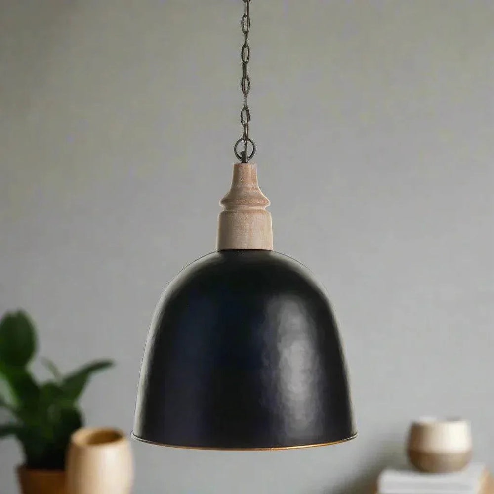 Small black dome pendant with wood above the shade, hanging over a table with pottery and greenery, Modern Farmhouse style