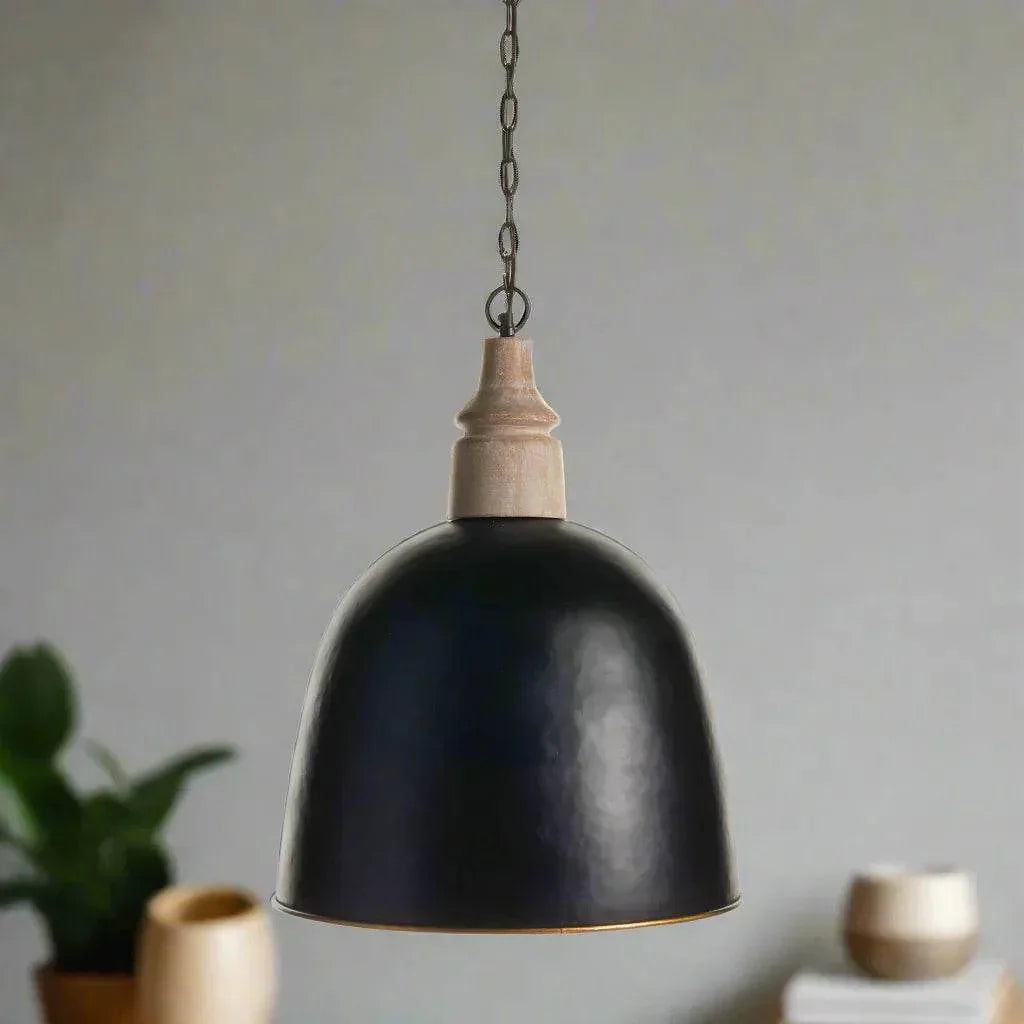 Small black dome pendant with wood above the shade, hanging over a table with pottery and greenery, Modern Farmhouse style