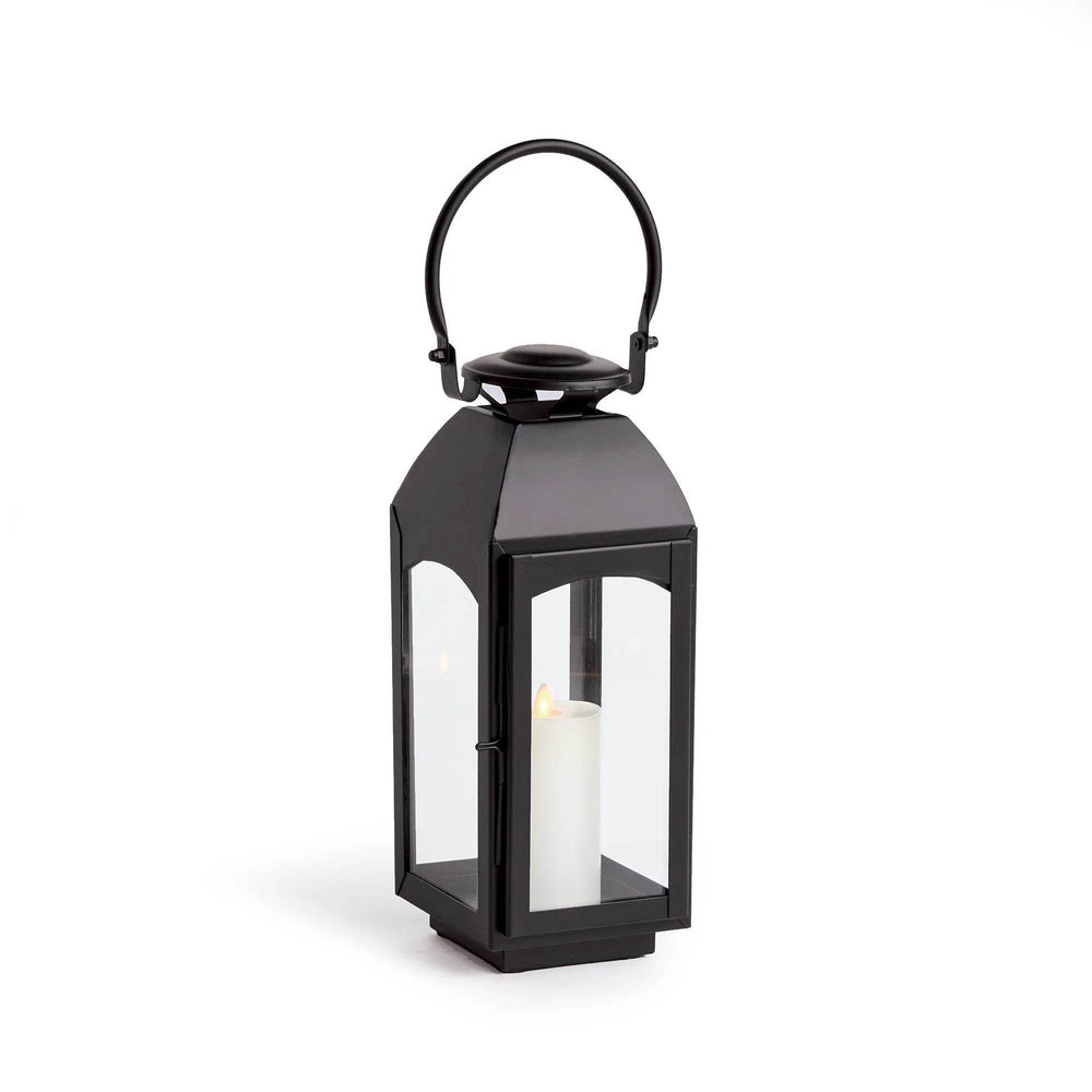 Small black outdoor lantern with iron frame and four clear glass sides, straight studio view on white with pillar candle centered – Transitional Decor