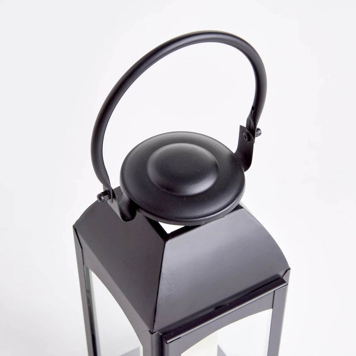 Close-up of domed cap and ring handle on black outdoor lantern, smooth powder-coated finish and hinge hardware visible – Transitional Outdoor Decor