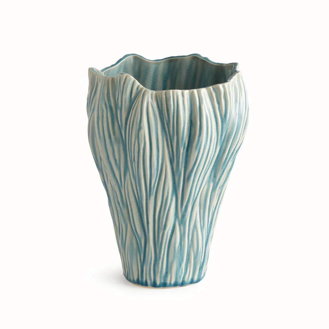 Small blue reactive glaze ceramic vase with flowing raised texture and an irregular rim, shown on white, Coastal Transitional