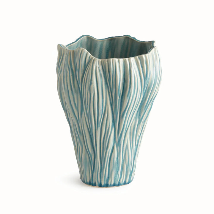 Small blue reactive glaze ceramic vase with flowing raised texture and an irregular rim, shown on white, Coastal Transitional