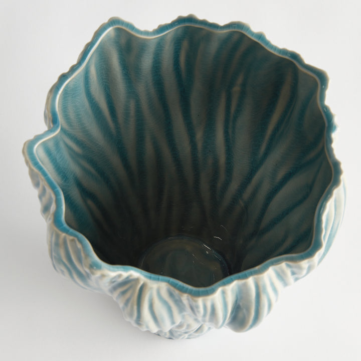 Overhead view into a small blue reactive glaze ceramic vase showing the uneven rim and glazed interior, Coastal Transitional