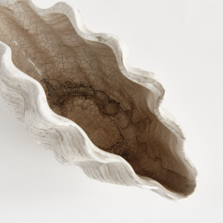 Top view into a small cream clay shell vase showing the narrow opening, wavy rim and antiqued interior, Coastal Transitional