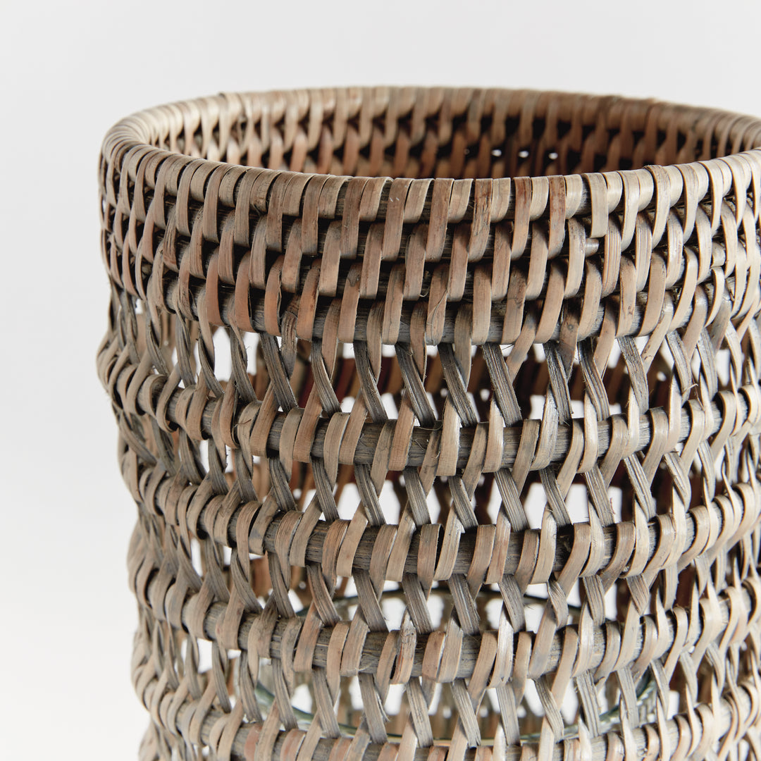 Close view of a small graywash rattan hurricane showing the woven rim and open woven pattern against white, Transitional