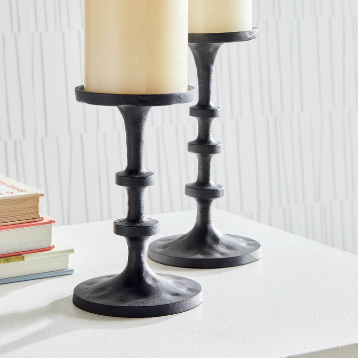 Side view of pair of small industrial black bronze candle holders highlighting stepped column design and round bases – Minimal Decor