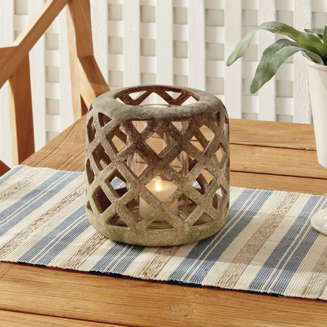 Small moss terracotta hurricane candle holder styled on striped runner with candlelight – European Rustic style.