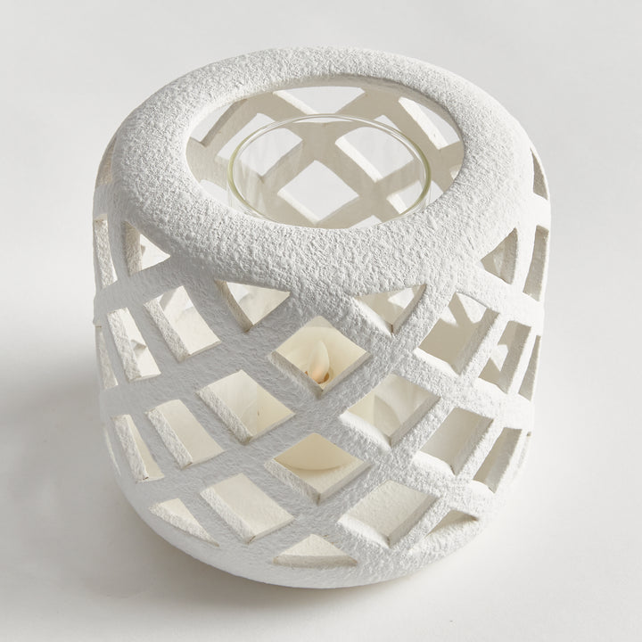 Angled view of small white terracotta hurricane candle holder with lattice cutouts – Coastal Transitional style.